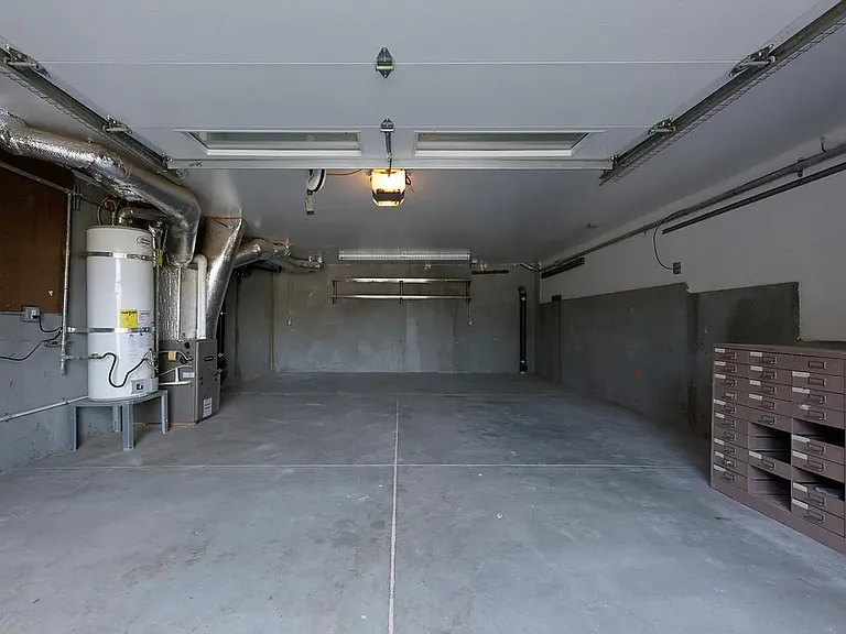 Attached garage below with up to two cars (compact) side by side parking. Additional third parking spot (tandem) available in driveway