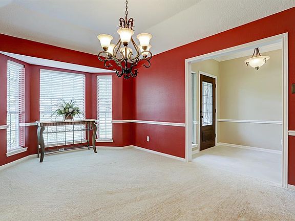Another view of the dining room and entry.