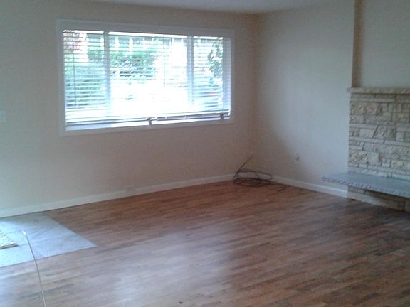 Bright. Open. Hardwoods. Energy efficient windows w/ wooden, cordless blinds throughout, wood burning fireplace. Firewood storage rack in backyard next to patio.