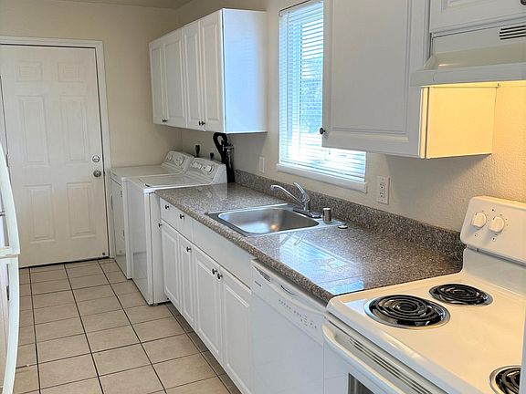 Galley Kitchen with refrigerator, dishwasher, washer & dryer