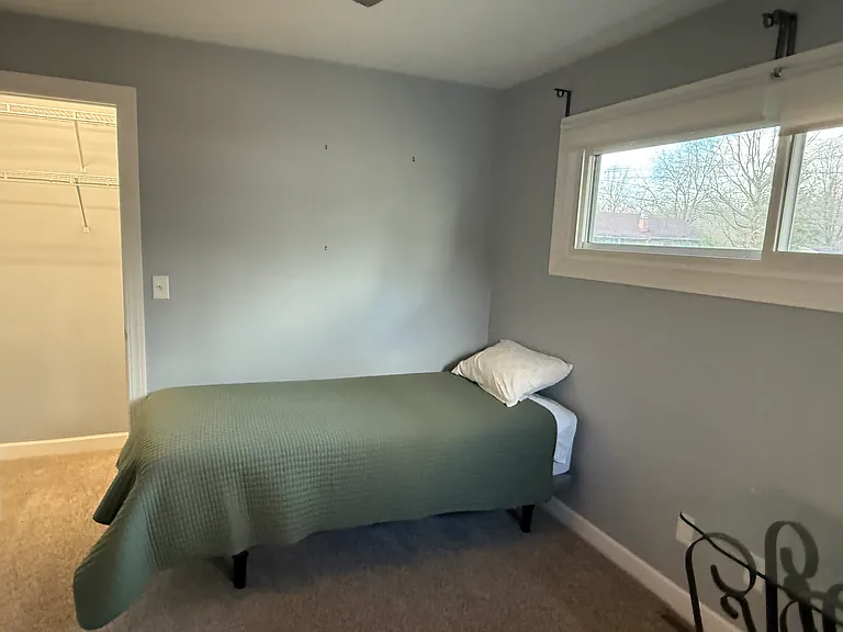 Large guest bedroom with twin bed with remote adjustable base