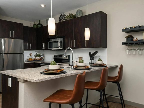 Kitchen with Granite Countertops, Bar Seating, and Modern Fixtures