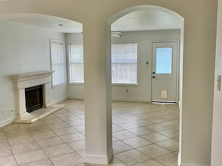 Family room with fireplace. Notice the nice arches for additional character.