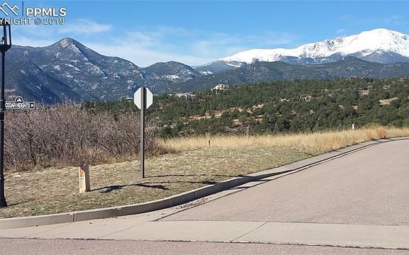 View of the lot - property line starts in the corner of Cedar Heights Dr and Cavern Ridge Rd. See the aerial pictures * Unobstructed views of the mountains from Cheyenne Mountain to Pikes Peak!