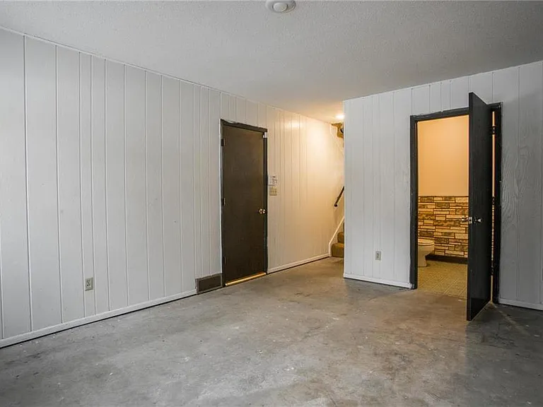 1st floor lower level. Perfect for an office/rec room. Has 1/2 bath and laundry room