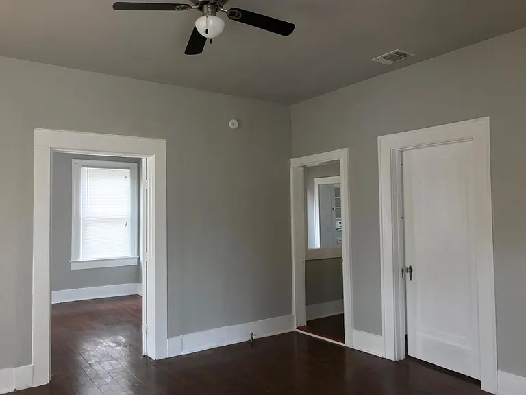 Large living room with ceiling fan. Shows split bedroom floo