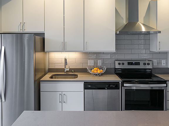 Beautifully appointed kitchen with quartz countertops and stainless steel appliances.