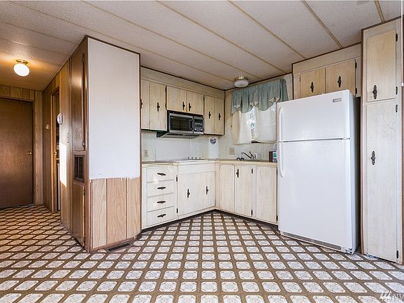 Hallway to bath and two bedrooms is at left.  Kitchen needs stove replaced.  