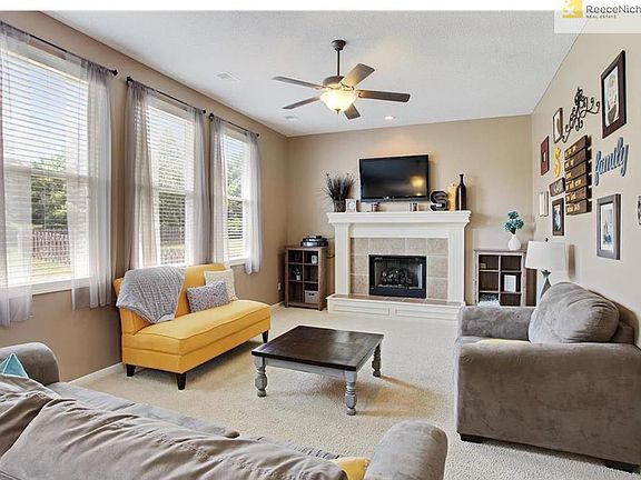 Gorgeous sunken Great room with lots of light!  Fireplace with gas log, Neutral Decor and upgraded ceiling fan.