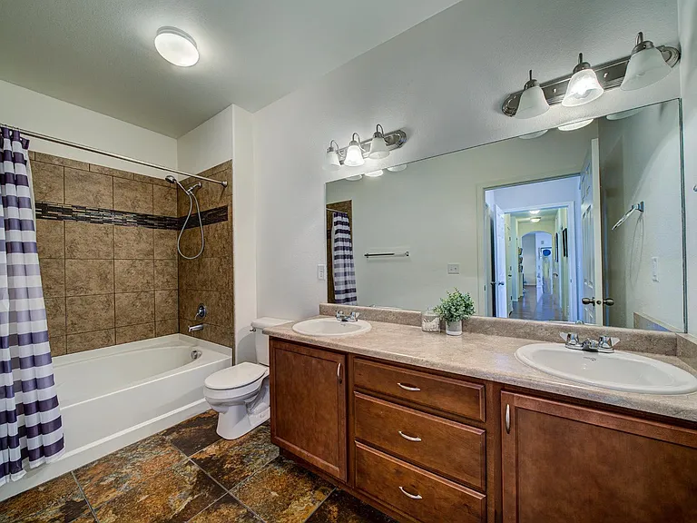 Master bathroom with two sinks and extra large bathtub.
