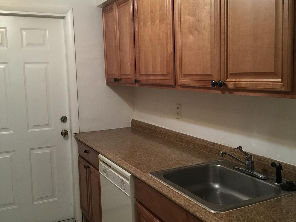 new kitchen cabinets and kitchen now has stackable washer and dryer by door