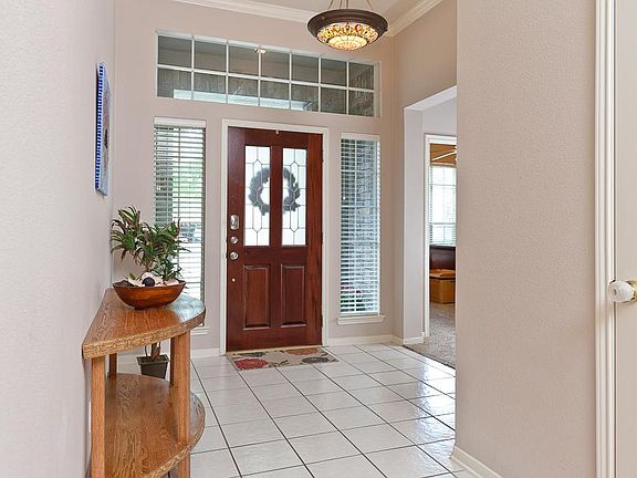 Bright and welcoming, all tile entryway!  The home has neutral colors and lots of windows, allowing plenty of natural light into the home!