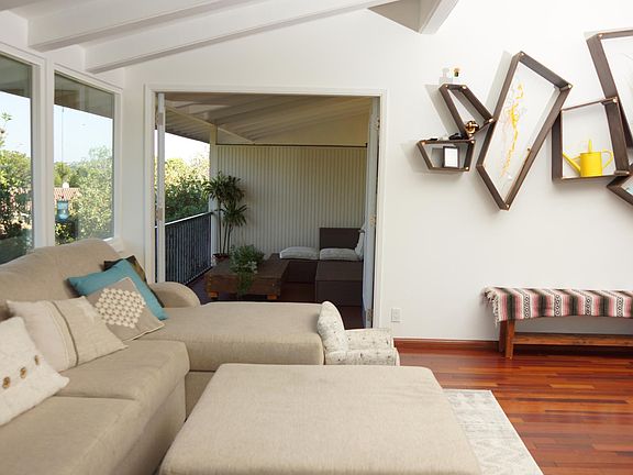 View from dining table to the upper floor balcony. We leveled the floor outside so when you open both doors, it extends the open space even more.