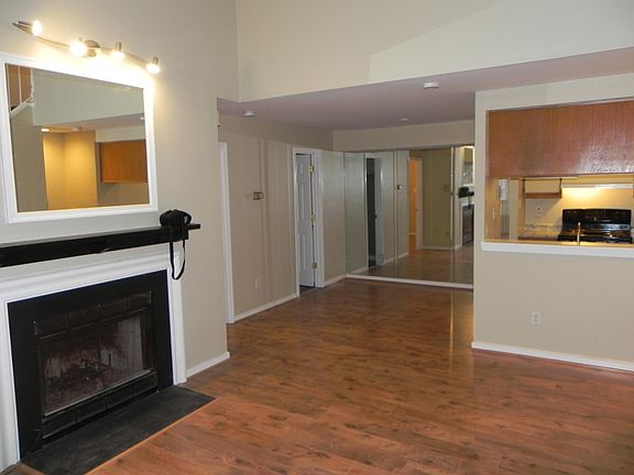 Main floor looking at dining area and kitchen. Fireplace inoperable
