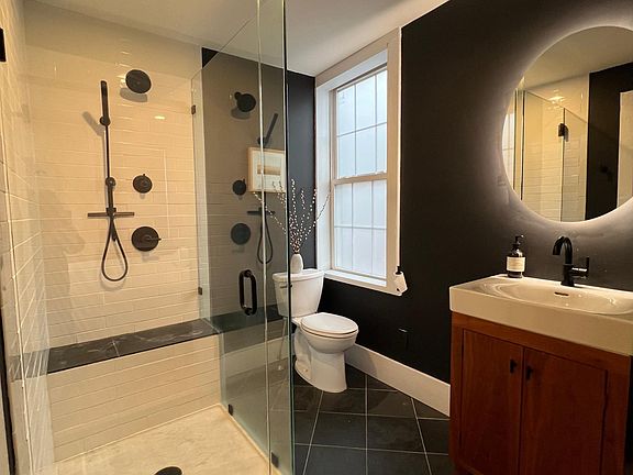 Custom cherry vanity, back-lit mirror.