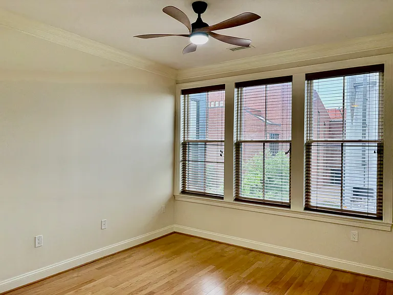Bedroom w/ Wall of Windows and LED Ceiling Fan.
