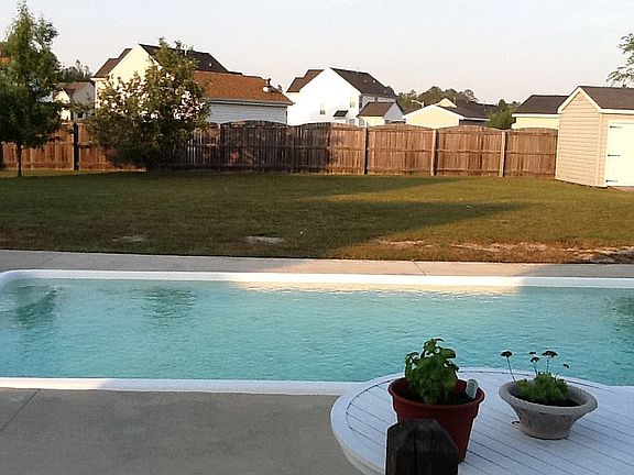 Large fenced yard with shed