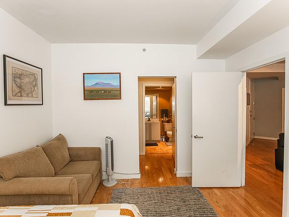 master bedroom, with a view through the closet doors and straight through into the master bathroom. Door to living room on the right.