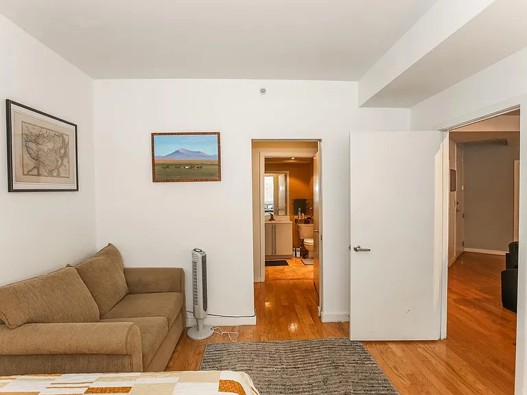 master bedroom, with a view through the closet doors and straight through into the master bathroom. Door to living room on the right.
