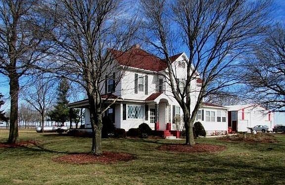 Surrounded by manicured, mulched mature trees