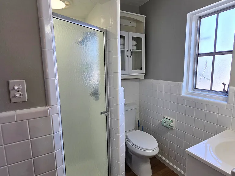 Impeccable bathroom with shower, sink, mirror, and toilet