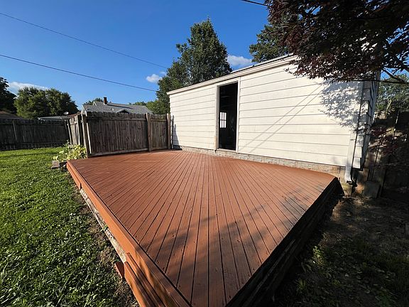 Newly sealed deck opening into garage.