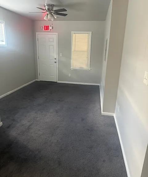 Living room looking from bedroom at the front door