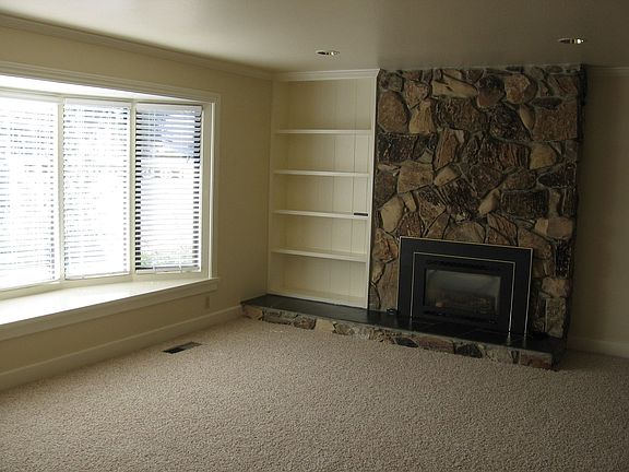 Large bay window and gas fireplace in formal living room
