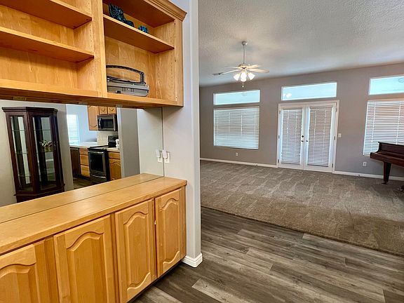 Just inside front door. Built in hutch and cabinets on left. Living rm. straight ahead