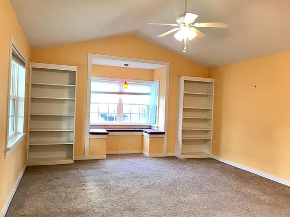 Large great room with a Bay Window it_s storage underneath, and twin bookshelves for all your books or decorative Knick knacks. Large enough for easy chair, table entertainment unit and a loveseat.