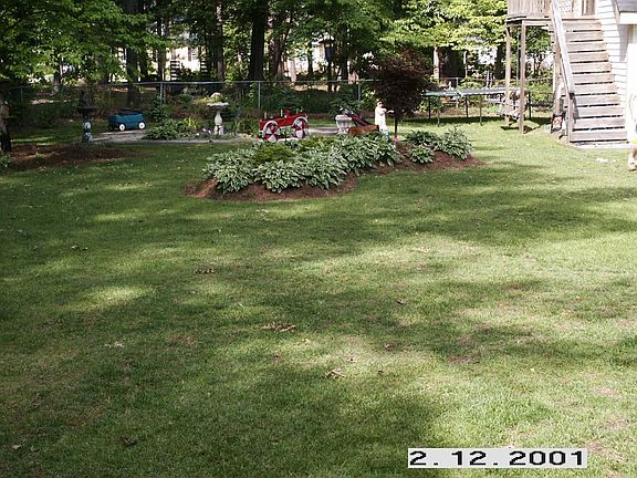 Left side-fenced backyard (stairs/balcony upstairs)