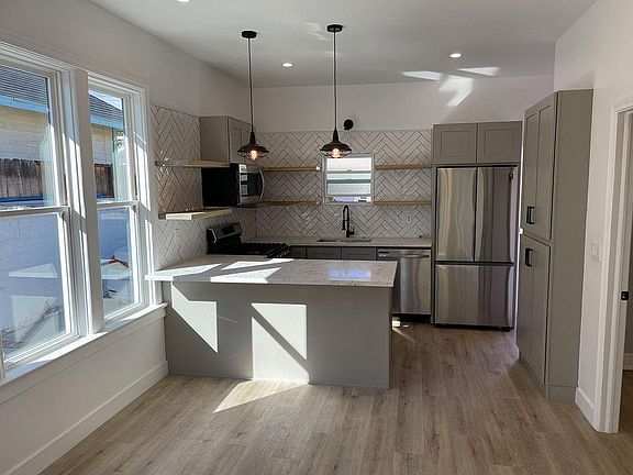Fully remodeled kitchen, with stainless steel appliances (dishwasher, fridge, microwave, range)