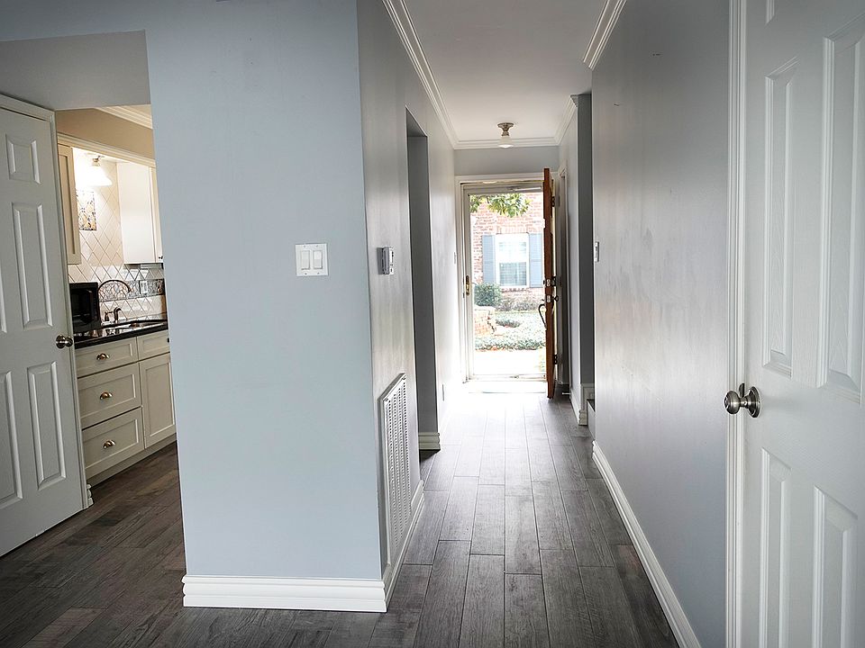 Kitchen to the left. Looking out through front door. Half bath behind the front door.