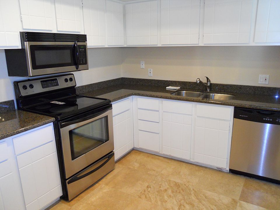 Kitchen with granite counter top & stainless steel appliance