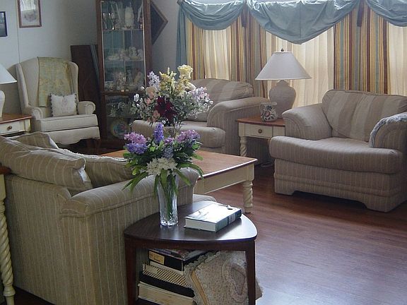Formal Living Room with new floors and a view of the floor to ceiling windows.
