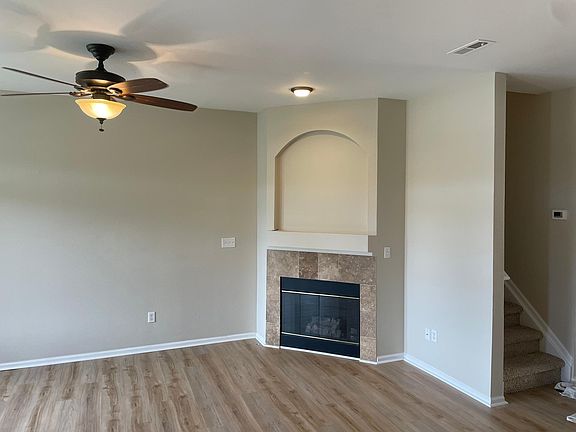 Living room with ceiling fan and gas fireplace