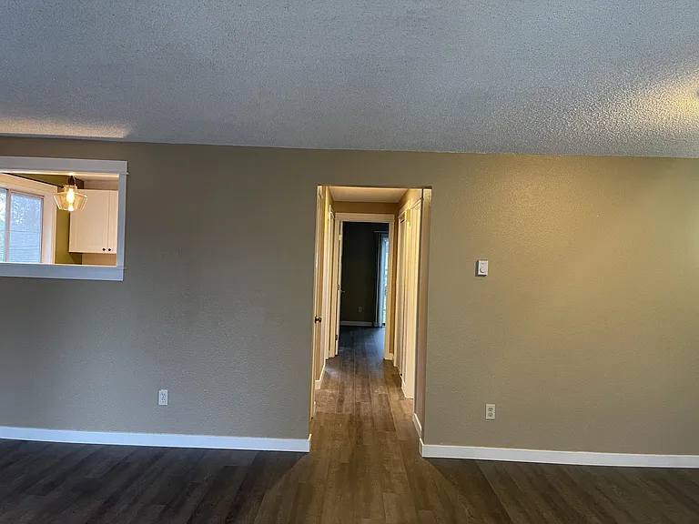Hallway leading to kitchen. bath, bathroom, and bedrooms