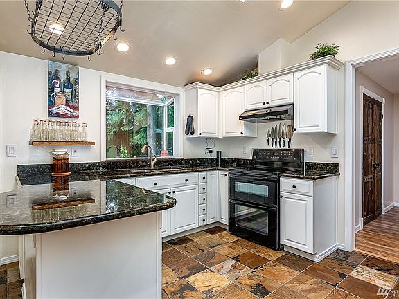 The spacious kitchen with abundant cabinets