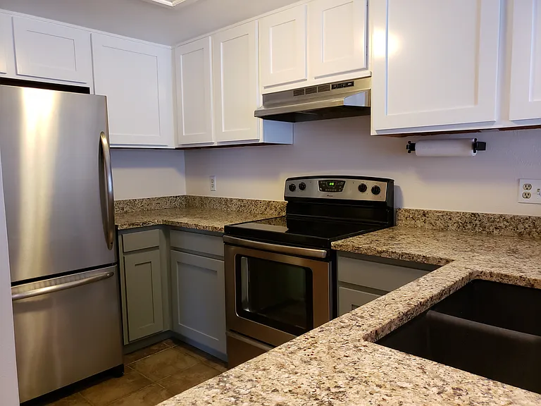 Kitchen : upgraded custom wood cabinet fornts. Stainless appliances. Granite counters and custom tile floors.