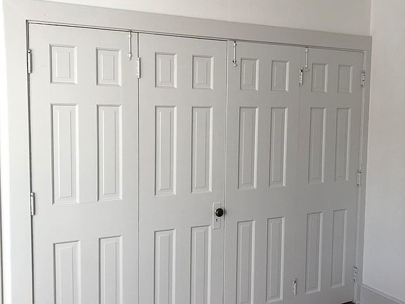 Three doors open to an optional place for plasma screen tv. Right side has shelving for books.