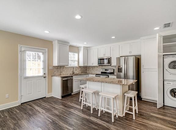 Kitchen/Living Area (laundry cabinet open).
