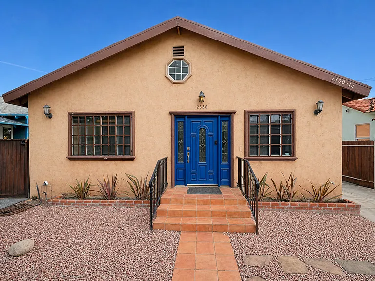 Main tiled entrance with Sahara rose rock and drought tolerant plantings.