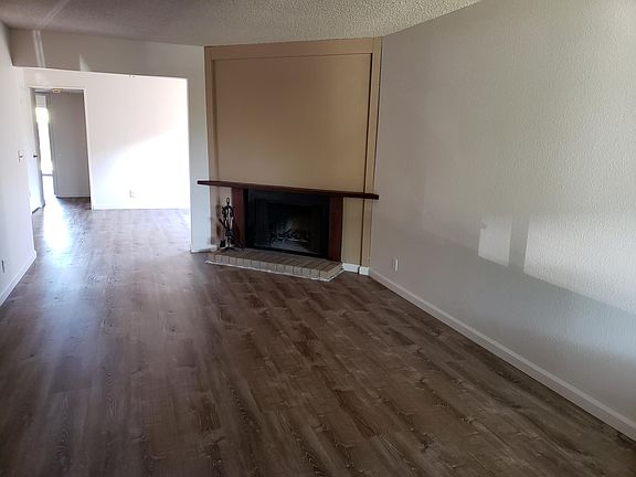 Living room w wood burning fireplace.