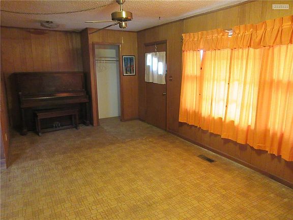 Living room view of the front door and coat closet.
