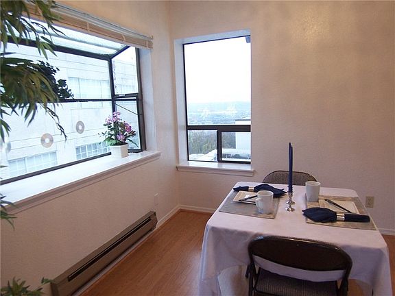 Greenhouse window brings light into the dining room all day. Look out over the south Elliott Bay harbor...active by day, sparkling by night.