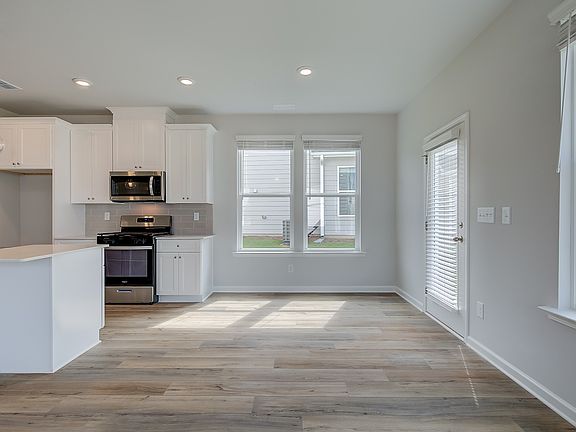 Open breakfast area in new construction townhome with expansive windows and natural light.