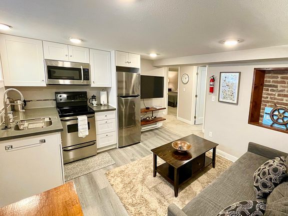 Kitchen, livingroom, TV, and hallway to bedrooms and bathroom.