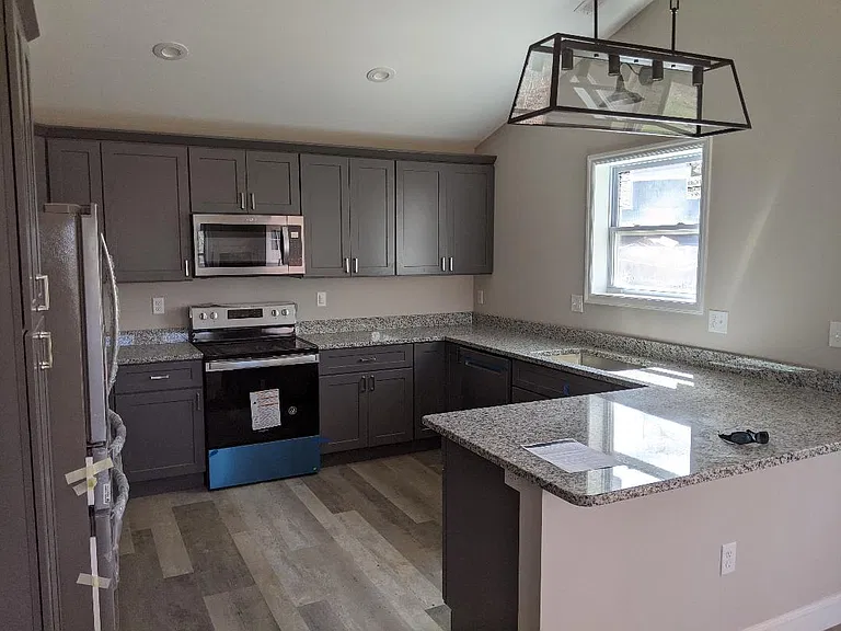 Large kitchen with granite countertops.