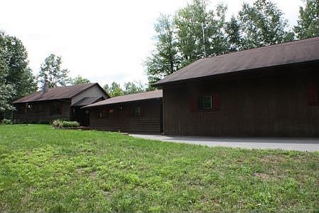 Front View of Home and Partial View of Garages
