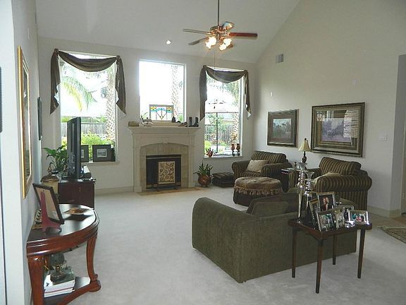  The large family room has high ceilings and large windows providing plenty of natural light. A gas log fireplace adds charm during the winter holidays.